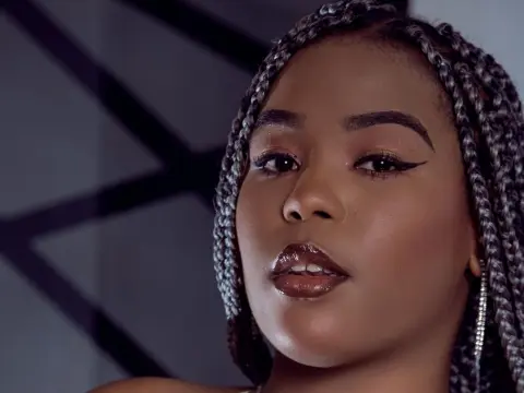 AshantyHopsom posing for a close-up portrait with her silver braids and winged eyeliner.