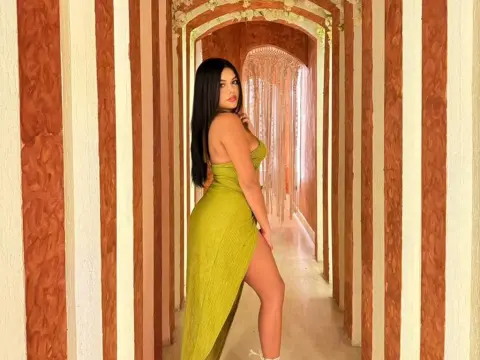 Elegant woman in a lime green slit maxi dress posing in a luxury striped hallway.