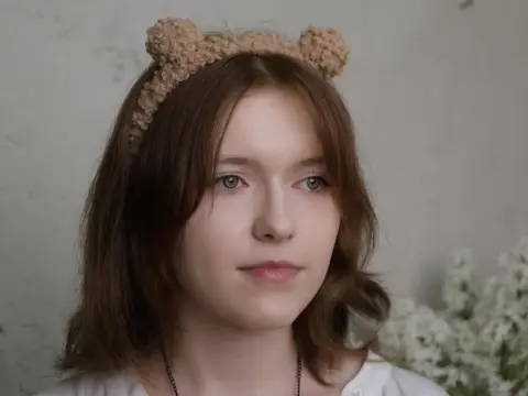 YukiPage — YukiPage looks into the camera wearing a fuzzy bear ear headband and a white shirt.