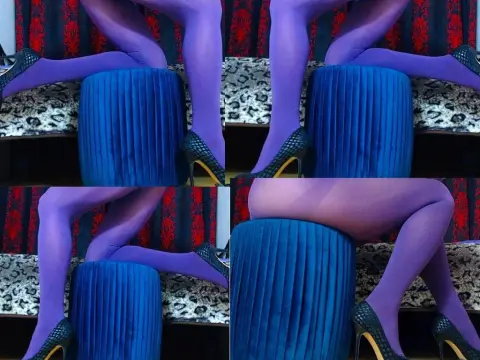 LUSTYKITTYMEOW — LUSTYKITTYMEOW poses in purple tights and black high heels while sitting on a blue velvet stool against a red patterned backdrop.