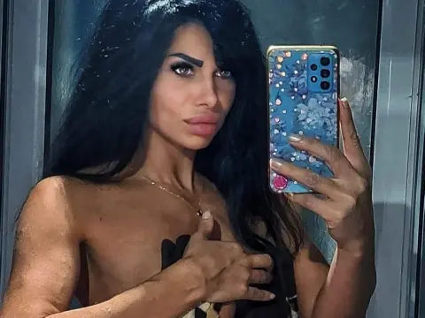 SelennaDream — SelennaDream takes a mirror selfie wearing a black top, showing off her long dark hair and tanned skin.