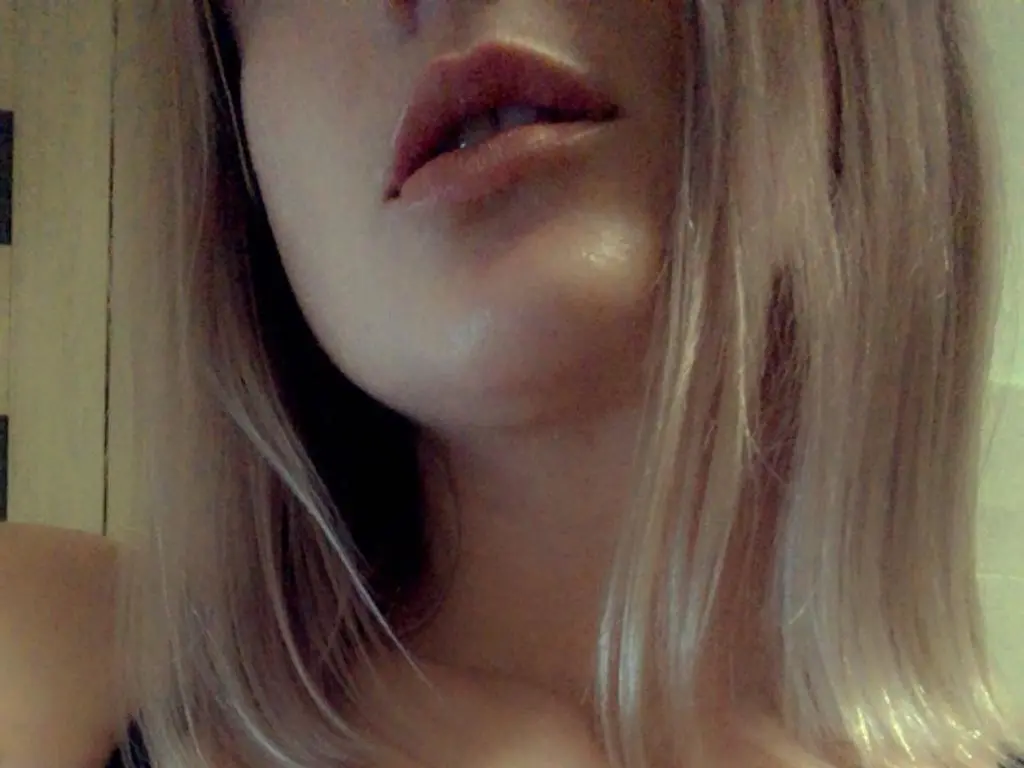 MarryEmma shows her face and blonde hair in a close-up shot, looking directly at the camera with her lips slightly parted.