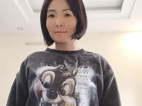 Mymy83 — Mymy83 looks at the camera wearing a dark grey graphic t-shirt with a cartoon squirrel print.