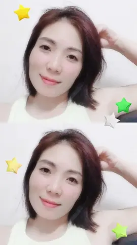 Mymy83 — Mymy83 smiles while resting her hand near her dark hair in a white tank top.