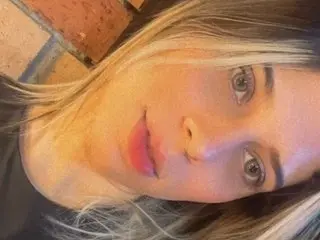 AMBARASM smiling for a close-up selfie with her blonde hair framing her face.
