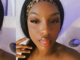 Close-up selfie of a beautiful Black woman wearing a leopard print headband with a playful expression.