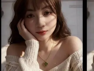 Agnes91 poses with her hand against her cheek, wearing a white off-the-shoulder sweater and a gold necklace, with her long brown hair down.