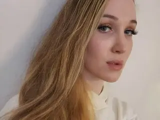 AireAzure poses with her long blonde hair down, looking directly at the camera against a plain white background.