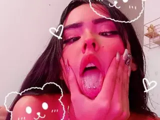AlondraConnor poses with her mouth open and hands cupping her face, showing her tongue and teeth.
