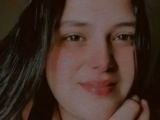 BIGCANDDY smiles for a close-up selfie, showing her dark hair and face in soft lighting.