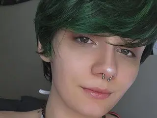 BarelyOlivia shows her face and short green hair, looking directly at the camera with a soft expression.
