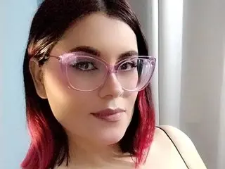 Bibi_Ramirez poses for a close-up selfie, showing her face, dark hair, and pink-rimmed glasses.