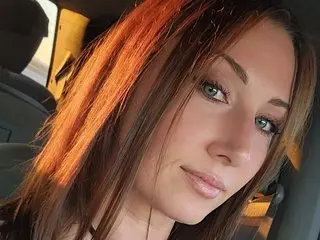 BlairHarper20 looks into the camera with a slight smile while sitting in a car.