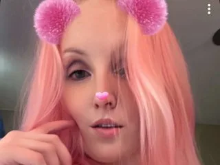 Breakingbarby — Breakingbarby with long pink hair and pink fuzzy ears looks into the camera.