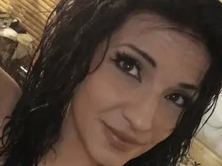CandyReign26 shows off her long, dark wavy hair and a close-up view of her face and shoulders.