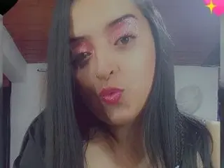 Candy_Curvyy with long dark hair and pink glitter eyeshadow pouts her lips at the camera.