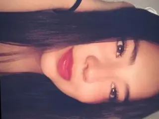 Candyqueentk shows her face and long dark hair while looking directly at the camera.