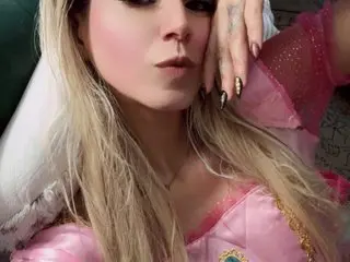 CelestialTorres poses with her long blonde hair down, wearing a pink lace top while looking directly at the camera.