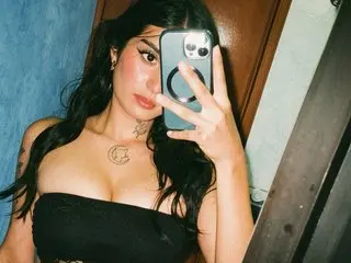 CelineCarter poses with long dark hair, wearing a black tube top and showing off a small neck tattoo.