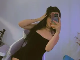 Chloemeww takes a mirror selfie wearing a tight black dress and a choker, posing with her hand in her long dark hair.