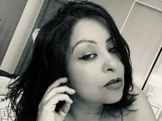 Crisselt poses with her dark hair framing her face, looking directly at the camera with a soft expression.