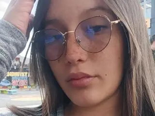 Crystalxx69 looks directly at the camera with a close-up headshot, showing her face and light brown hair.