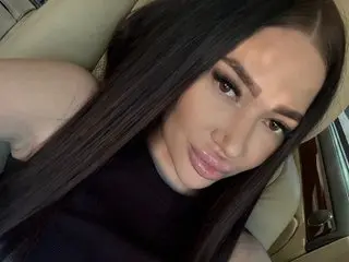 Darkobsessions poses close-up with long black hair, wearing a black top, showing her face and shoulders.