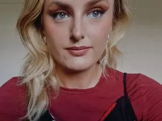 EmiWinters23 poses close-up with her blonde hair down, wearing a red top and looking directly at the camera.