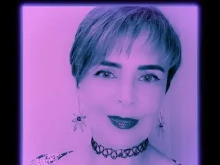 Evalovehot69 looks at the camera with short dark hair, wearing a black lace choker and dark lipstick against a purple background.