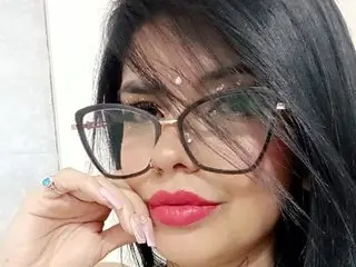 EvelingJoy77 poses close-up, looking at the camera with long black hair and red lipstick.