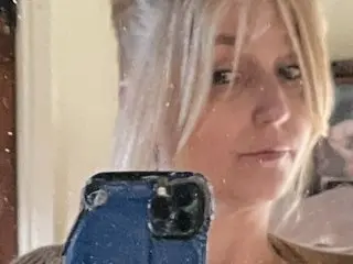 Fairydustlife72 takes a close-up selfie with her phone, showing her blonde hair and face.