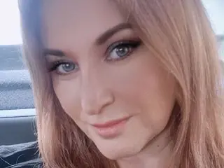 Fenix2026 poses with a close-up headshot, showing her long blonde hair and light eyes while looking directly at the camera.