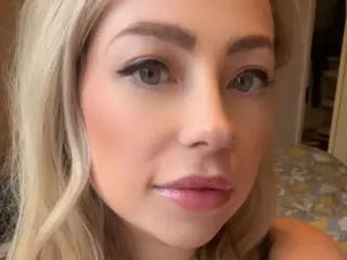 FrankiiRayeXXXX looks into the camera with a soft smile, showing her blonde hair and light makeup.