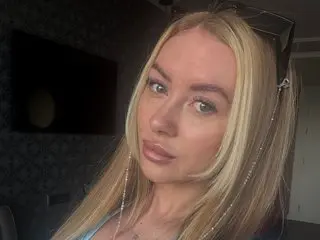 GiGiREDX with long blonde hair, looking directly at the camera in a close-up headshot.