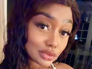 GiselleSanchez poses close-up, showing her face, dark hair, and lips with a direct gaze.