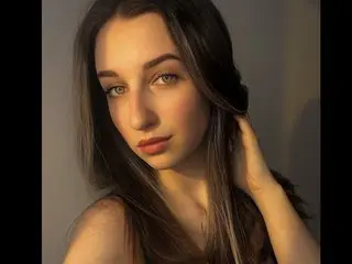 HeylaRose poses with her long dark hair framing her face, looking directly at the camera with a soft expression.
