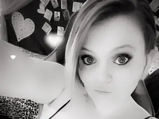 Honey_Chambers poses with her blonde hair swept to the side, showing her face and shoulder in a close-up shot.