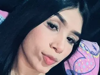 HotAngie42 poses with a close-up headshot, showing her long dark hair and light makeup against a dark background.