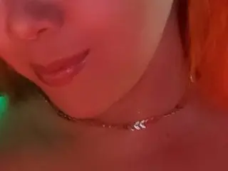 Jadeeford smiles while wearing a thin silver chain necklace against her skin.
