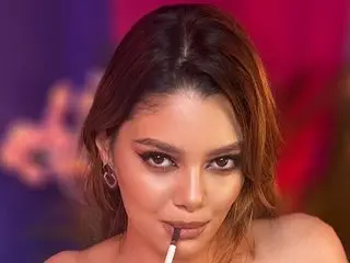JessicaJupiter poses with her hair pulled back, biting a dark lipstick-covered finger while looking directly at the camera.