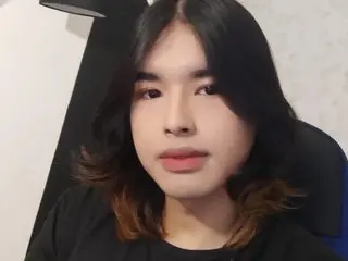 JordiWilld has long dark hair and is wearing a black t-shirt while looking directly at the camera in a close-up headshot.