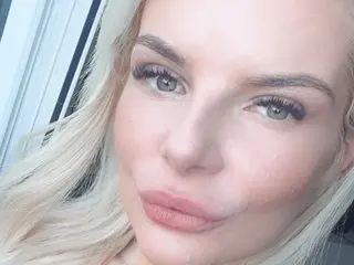 KadieBlondie is a blonde woman with blue eyes looking into the camera for a close-up selfie.