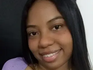 Karol_W smiling for a close-up selfie with long black hair and a purple top.