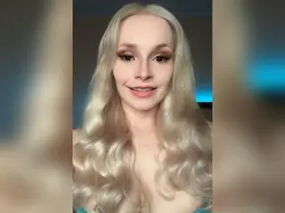 LanaBackwards poses with long, wavy blonde hair and light makeup, looking directly at the camera in a close-up shot.
