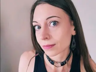 LaraWinters looks directly at the camera with long brown hair, wearing a black tank top against a plain light background.