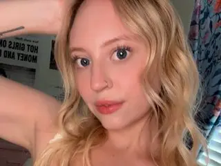LiliTurnerxo poses with her blonde wavy hair framing her face, looking directly at the camera with a soft expression.