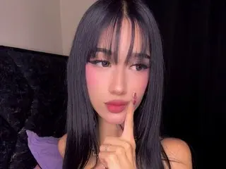 London_Rivers23 has long black hair with bangs and is looking at the camera while touching her chin with one finger.
