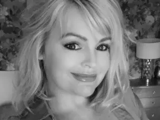 LottieLowe poses with a soft smile, showing her blonde hair and face in a close-up shot.