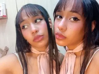 LovelyConnieD poses with a direct gaze, showing her face, dark hair with bangs, and a light pink halter-style top or necktie detail.