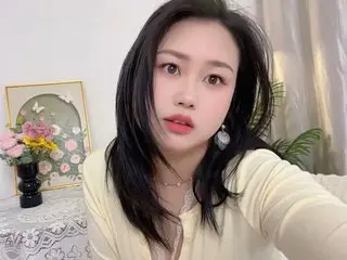 Lrenelvy poses close-up with long black hair, wearing a light yellow top in an indoor setting.